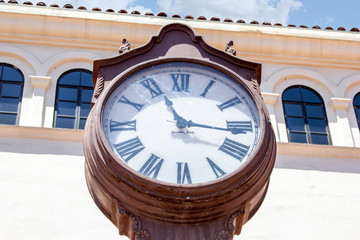 A vintage clock tower and classic architecture with a cloudy sky