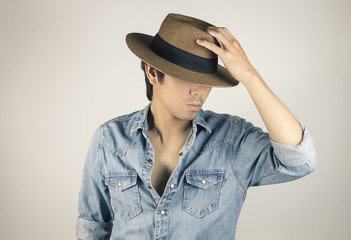 Portrait Man in Jeans Shirt or Denim Shirt Fashion Touching Hat in Vintage Tone