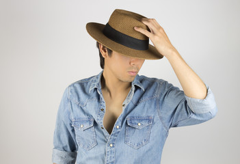 Fototapeta premium Portrait Man in Jeans Shirt or Denim Shirt Fashion Touching Hat