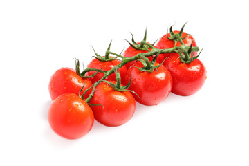Branch of fresh cherry tomatoes isolated on white