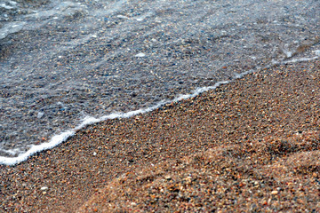 Sea water and beach sand close-up. Natural background