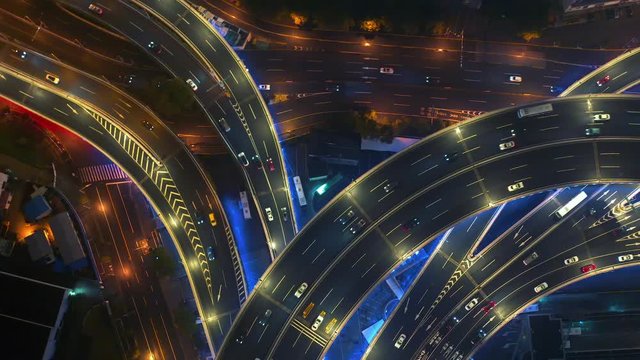Cars and big vehicles moving in neon lighted Nanpu bridge in Shanghai at night an aerial view, 4K clip
