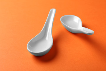 Clean Miso soup spoons on orange background