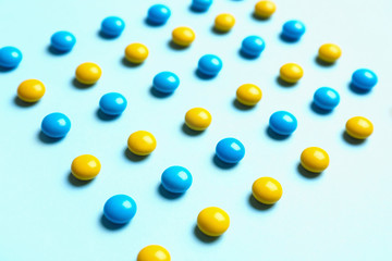Delicious bright candies on light blue background