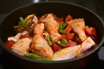Chicken curry cooking in a pan.