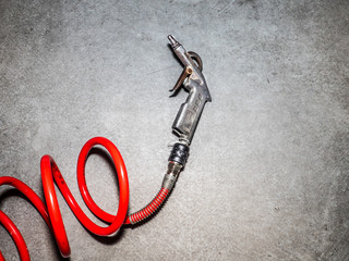 metal gun and red tube for compressed air system for cleaning mechanical parts