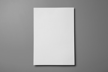 Blank paper sheets for brochure on grey background, top view. Mock up