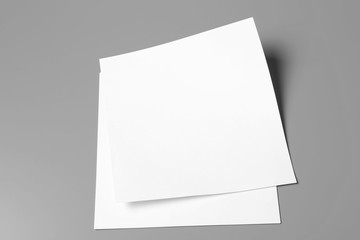Blank paper sheets for brochure on grey background. Mock up
