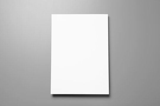 Blank paper sheets for brochure on grey background, top view. Mock up