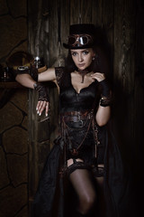 Fototapeta na wymiar Sexy young woman in the style of a steampunk