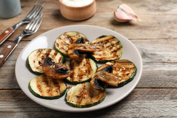 Grilled zucchini slices served on wooden table