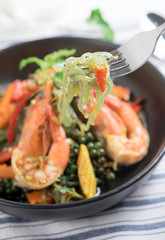 Spicy stir fried noodles with shrimp and holy basil leaves