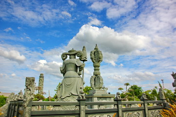 Fototapeta premium Chinese god stone carving with blue sky white cloud in Thai land.