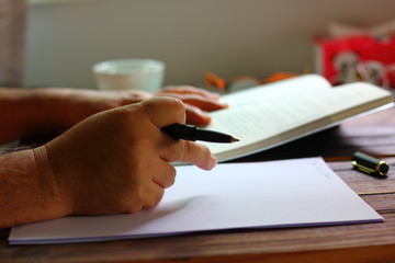 man holding the pocket book.retired worker spend the with book. writer is collecting information...