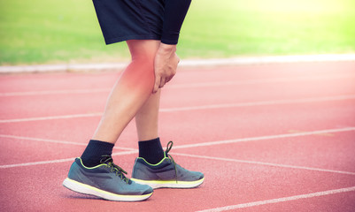 Fototapeta na wymiar Male runner knee injury and pain on running track,Injury from workout concept