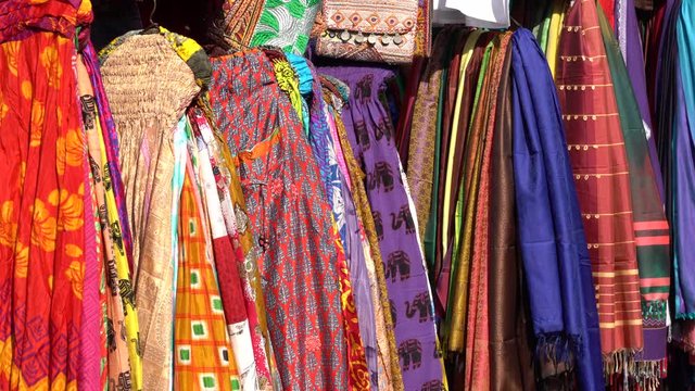 Assortment of colorful clothes for sale in local street market in Udaipur, Rajasthan, India. Close up