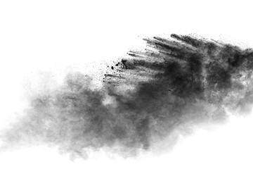 Black powder explosion on white background.Black dust particles splash.