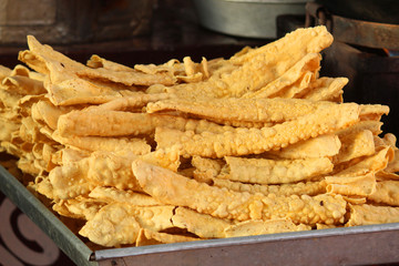 Indian Cuisine Fafda on street road, eating with hot tea, Most popular indian all time snack, selective focus.