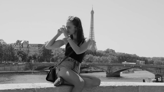 Young woman loves to take photos in Paris