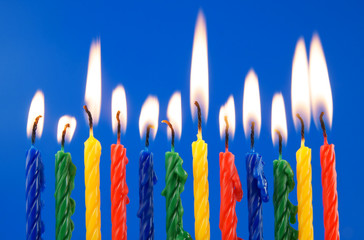 Burning birhday candles on blue background