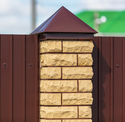 Brick pillar on the fence