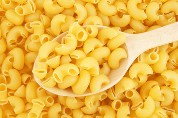 Pasta with wooden spoon close up