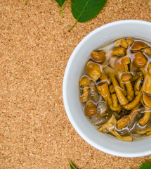 pickled mushrooms in a deep plate against a brown background