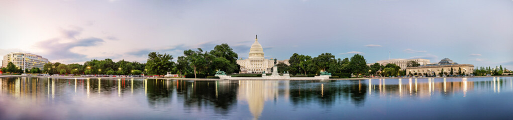 Panorama view of the United States Capitol building reflected on the reflection pool when sunset at...