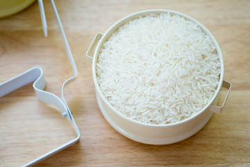Raw white Jasmine rice in tiffin Thai food carrier