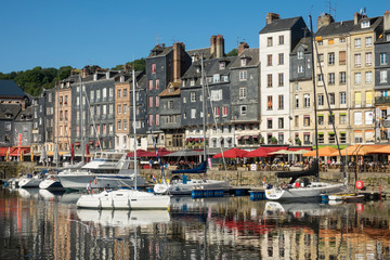 Fototapeta premium HONFLEUR, FRANCE - July 29, 2019: sailboats and pleasure boats are anchored in the port of Honfleur, France