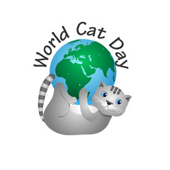 Cheerful gray cat playing with a globe