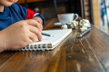 Close up photo of Asian student drawing on sketchbook