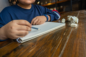 Young designer using pencil and drawing on blank sketchbook 