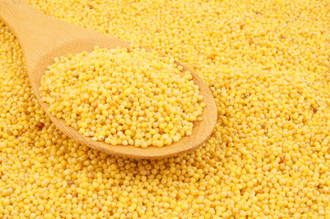 Millet with wooden spoon