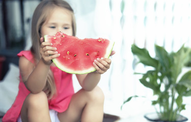 Young family eating a juicy red watermelon