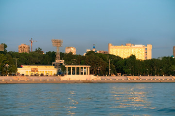 Naklejka premium View of the city of Khabarovsk from the Amur river. Urban landscape in the evening at sunset.