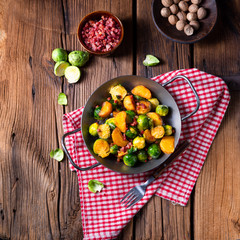 Brussels sprouts potato pan with bacon in rustic style