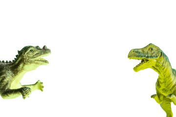 two toy dinosaurs fall into the frame from different sides