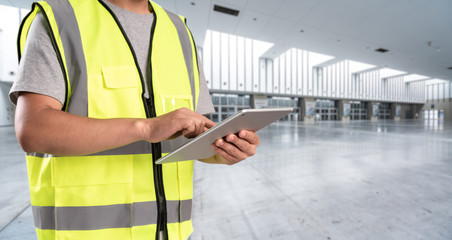 worker hand holding pad for check order pick time in empty warehouse