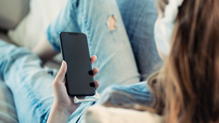 Young woman using mobile phone at home