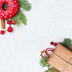 Christmas background. Xmas composition with green Xmas fir branch, gift, red holly berries and...