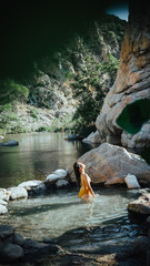 Asian girl flipping hair in water at deep creek hot springs