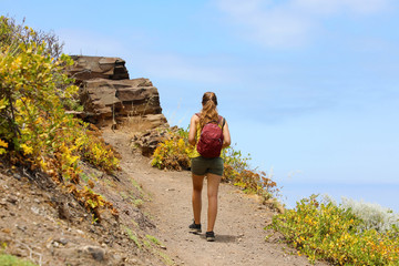 Naklejka premium Young woman backpacker hiking at beautiful mountain on Tenerife Island
