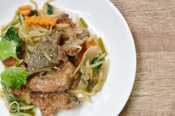 deep fried chop fish with slice ginger and celery on plate