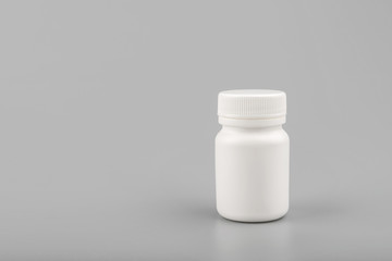 medicine white pill bottle on grey background