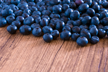 Blueberry berry on a wooden table. Summer and vitamins