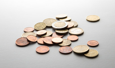 European Euro coins spilled on white surface