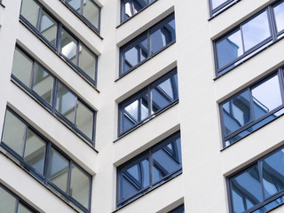 The windows of a multistory building are angled. fragment of a multi-storey residential building