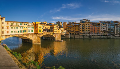 Fototapeta premium Ponte Vecchio bridge over Arno river in Florence city, Italy in the sunset