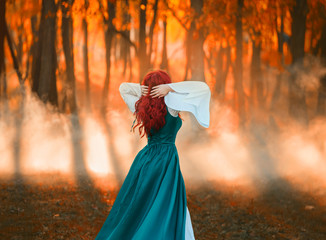 girl with bright red wavy hair sanding with back to camera, lady in green cloak and white dress...